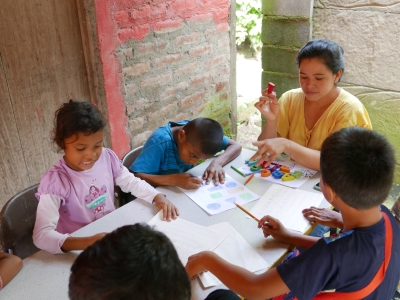 The children receive help with the schoolwork