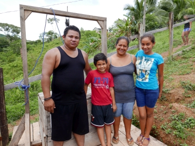A family standing in front of their well